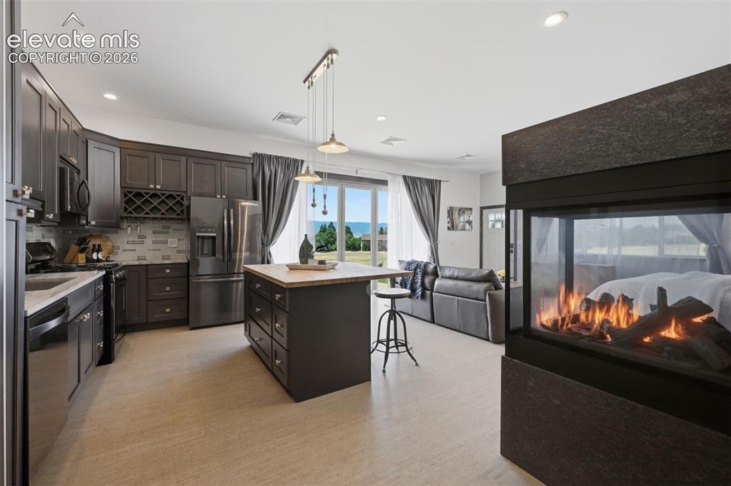 Image 44 of 48: Detached guest room with full kitchen, fireplace, walk in closet and walk o