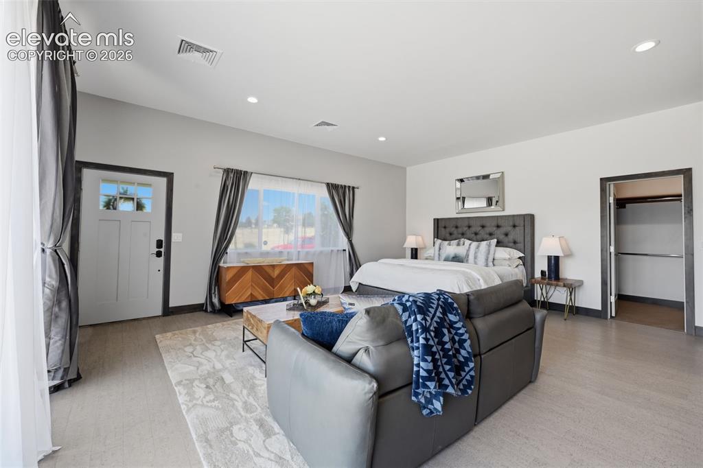 Image 45 of 48: Another view of the guest room showing the main living space and walk in cl