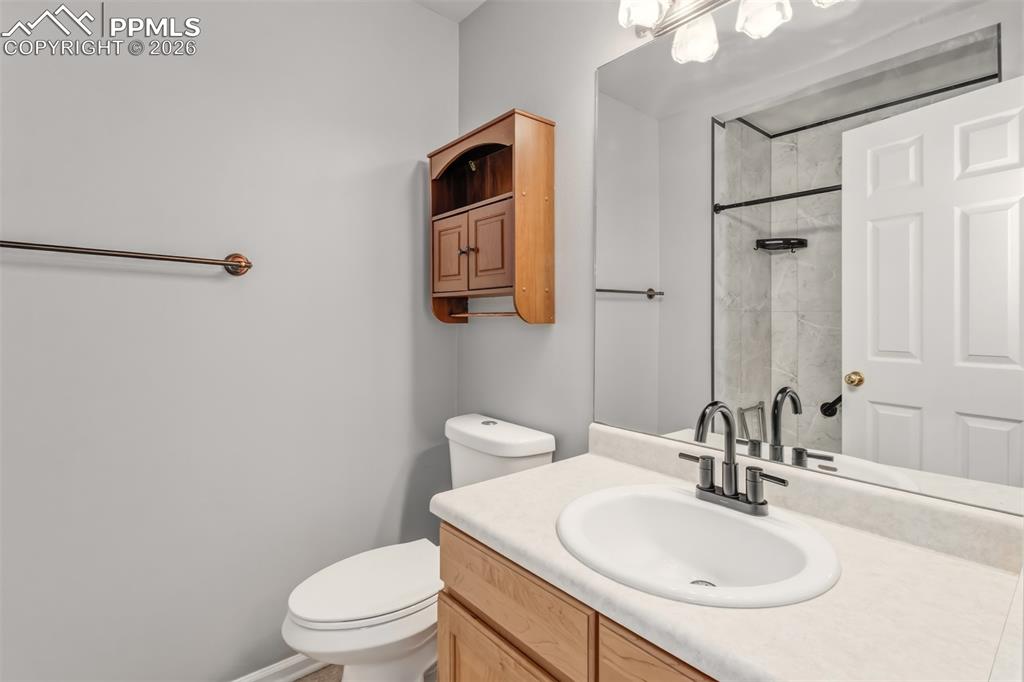 Image 13 of 27: Master bathroom featuring vanity and an upgraded shower with storage/medici