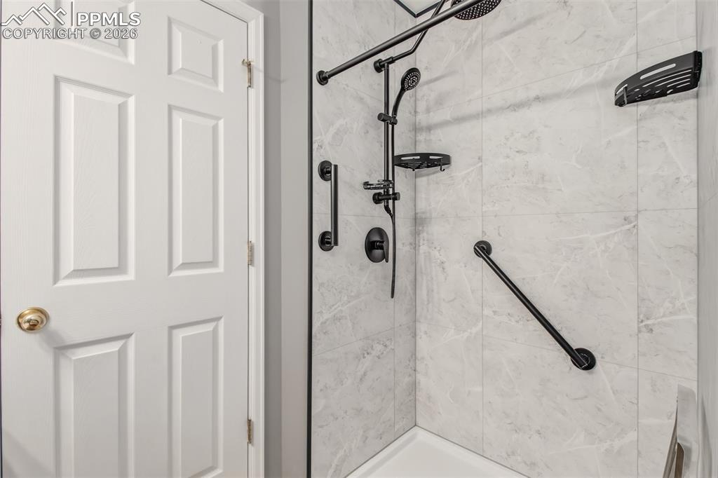 Image 14 of 27: Master bathroom with an upgraded modern style shower stall