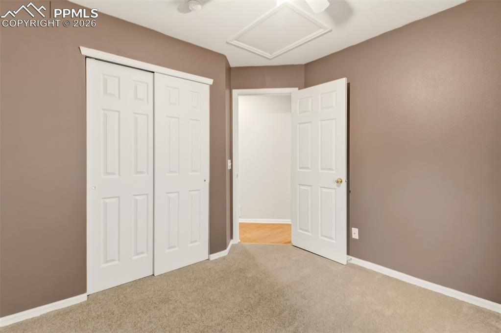 Image 16 of 27: Bedroom 2 featuring light carpet and a wall closet