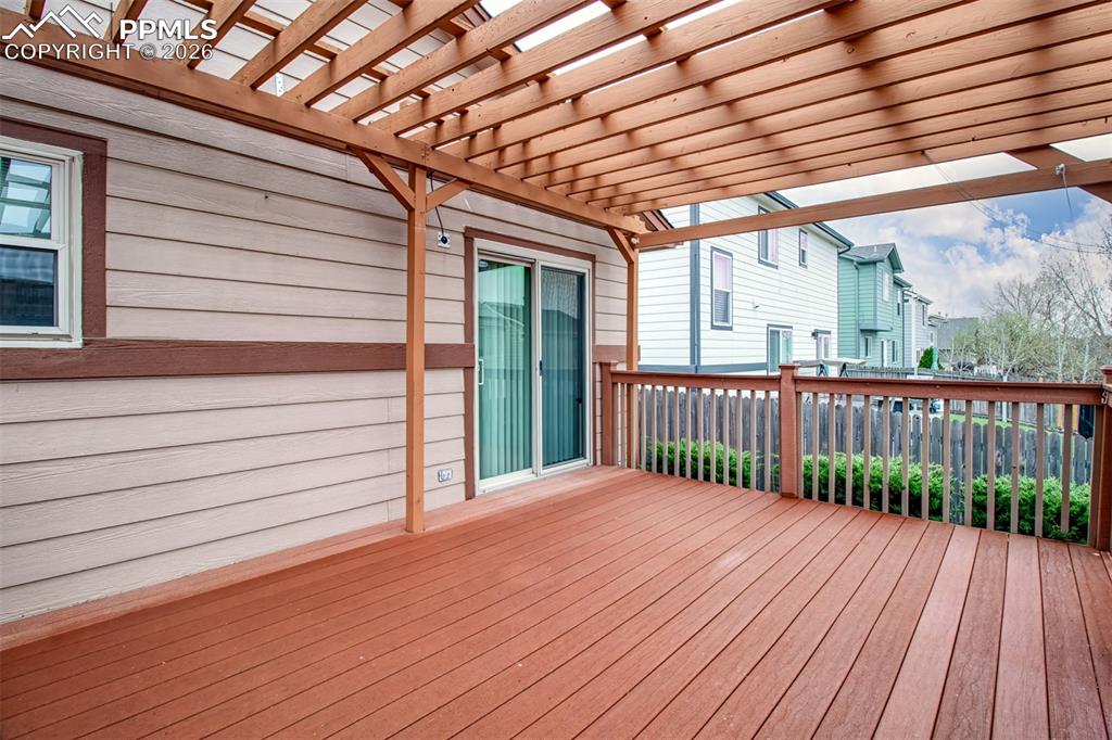 Image 22 of 27: Wooden terrace with a pergola