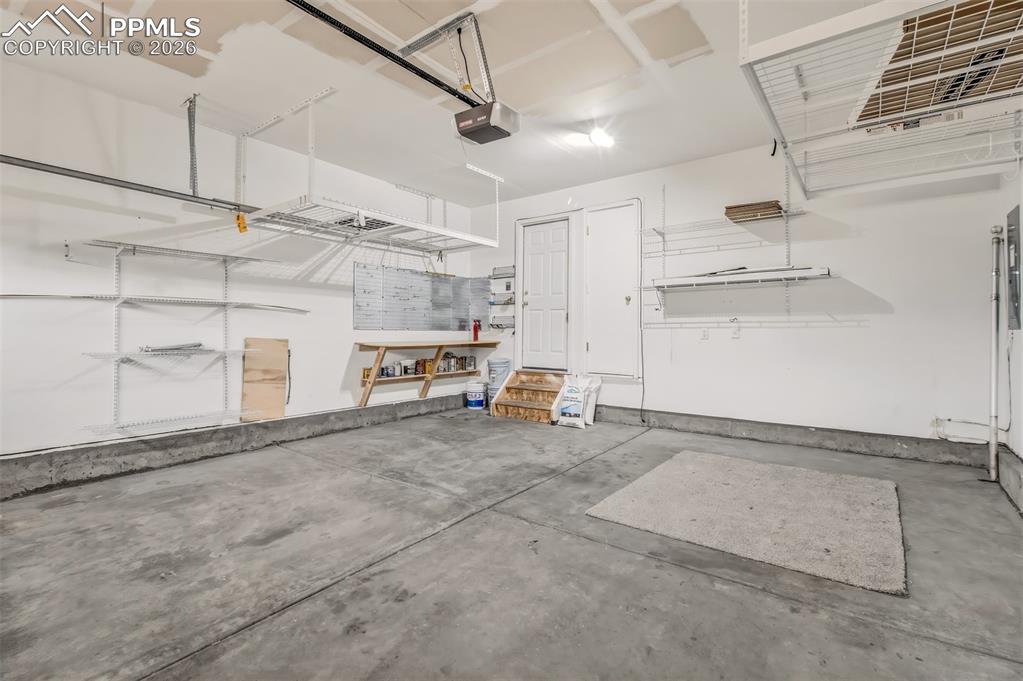 Image 27 of 27: Garage featuring a garage door opener