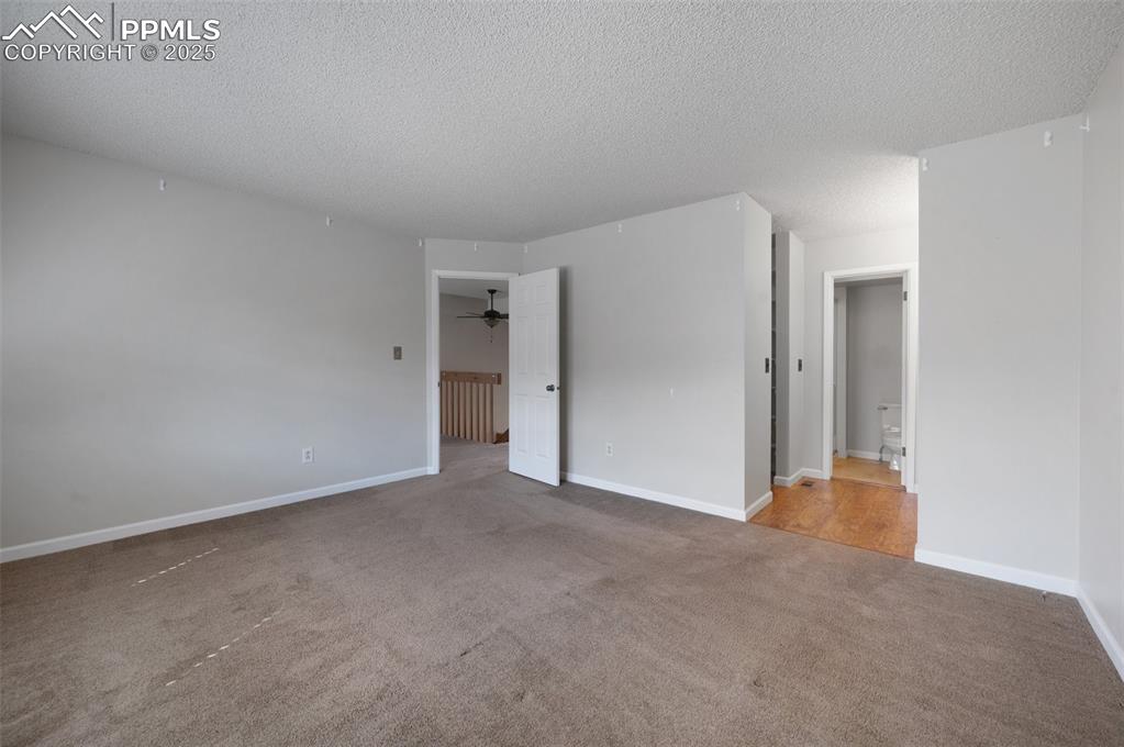 Image 14 of 39: Primary bedroom with adjoining bath and walk in closet