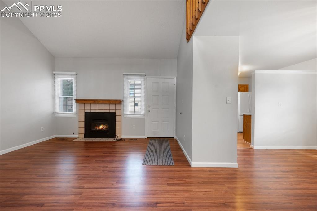 Image 5 of 39: Living room with cozy fireplace