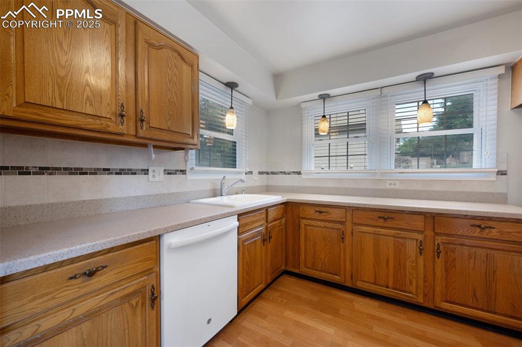 Image 8 of 39: Kitchen with solid surface counters.