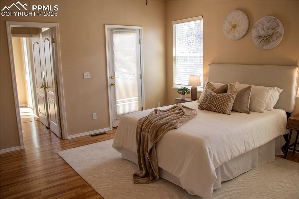Image 13 of 31: Bedroom with wood finished floors and baseboards
