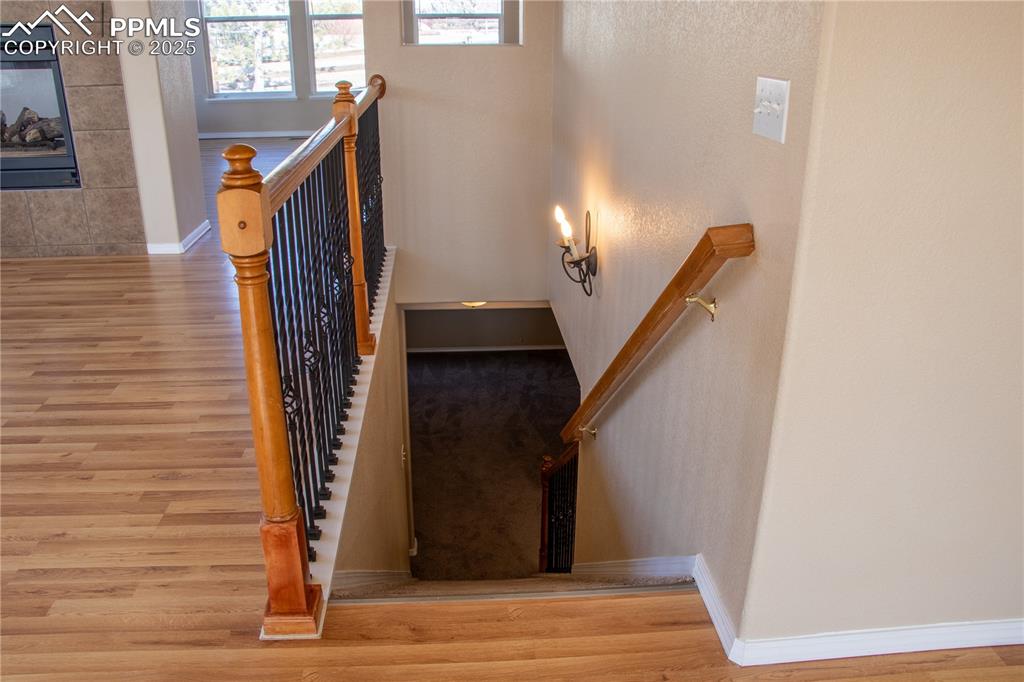 Image 17 of 31: Stairs featuring wood finished floors