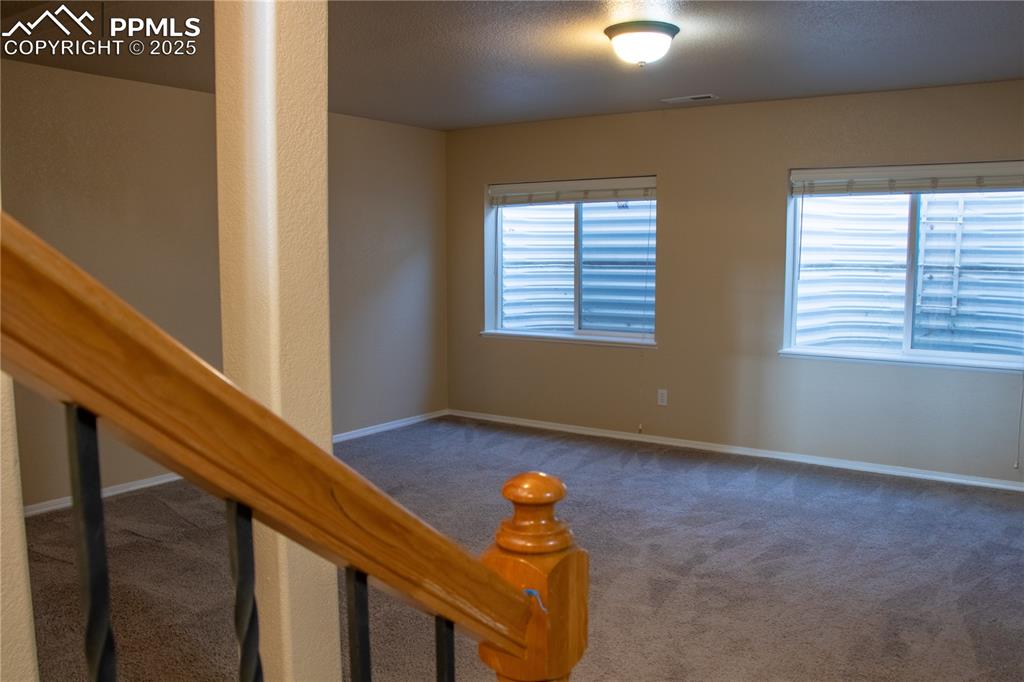 Image 20 of 31: Carpeted empty room with baseboards