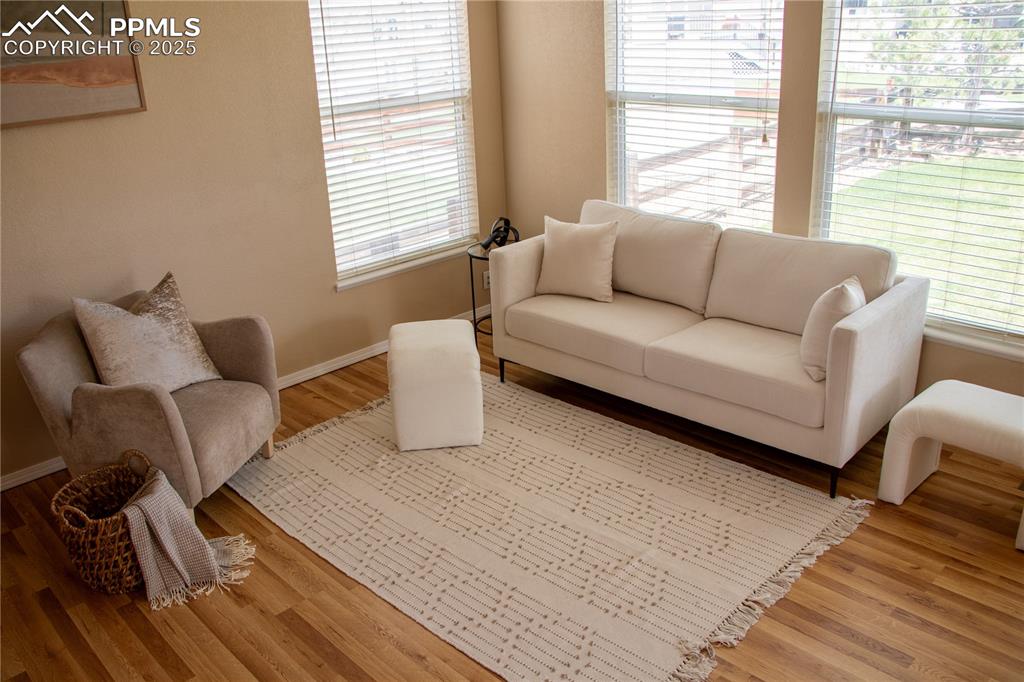 Image 8 of 31: Living room with wood finished floors and baseboards