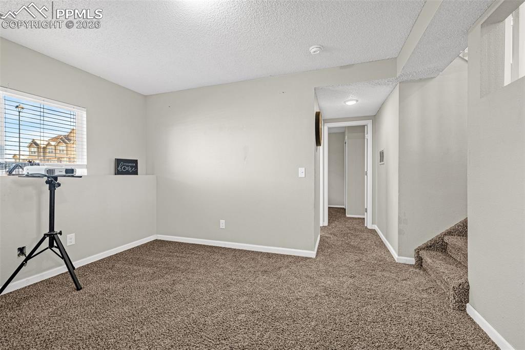 Image 18 of 35: Lower level family room with fireplace
