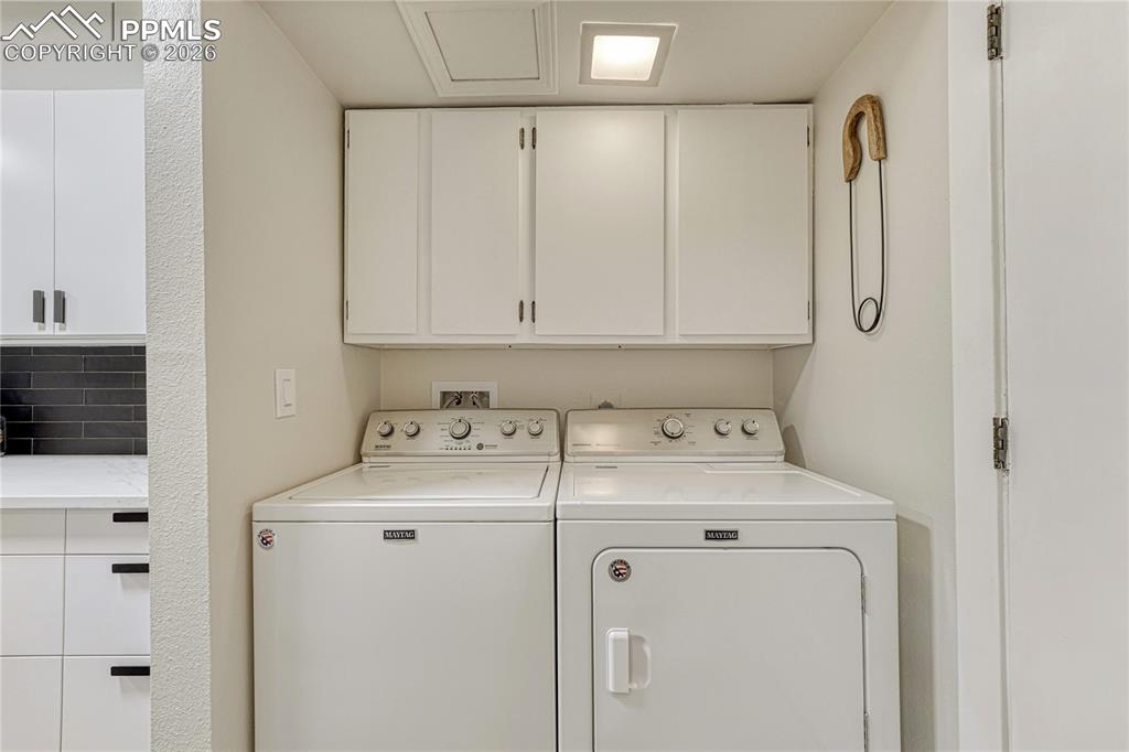 Image 18 of 50: Main level laundry, at the end of the kitchen just before the garage door e