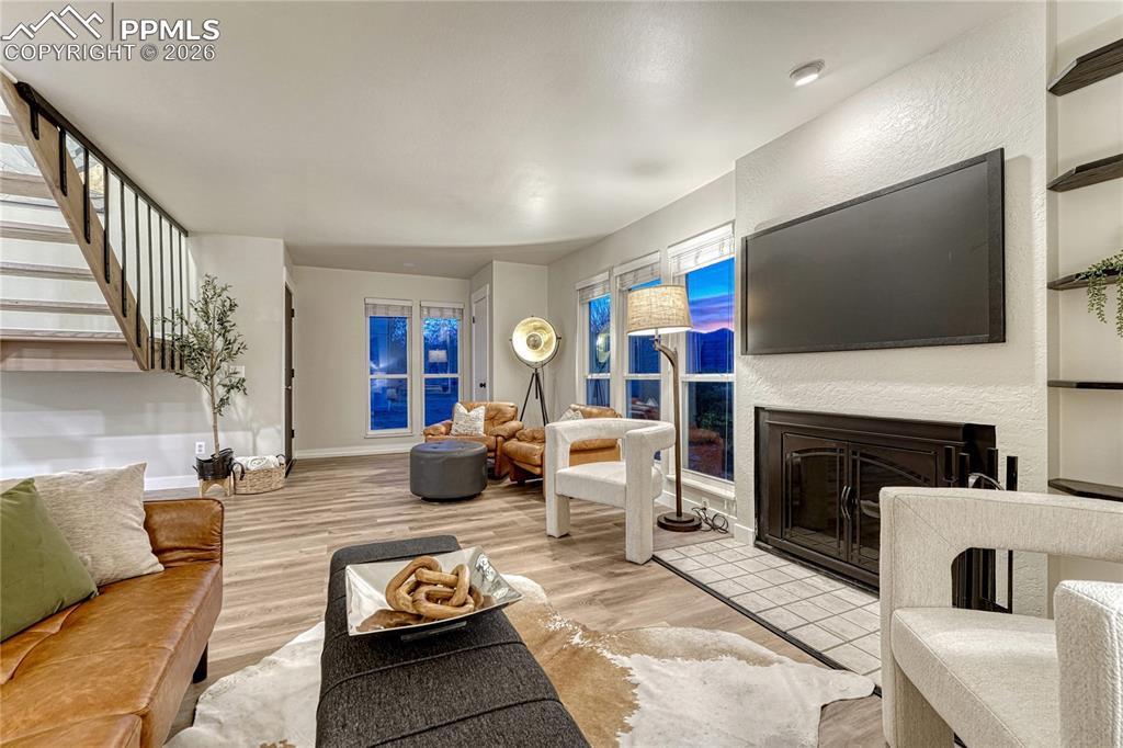 Image 4 of 50: A cozy woodburning fireplace in the Living Room