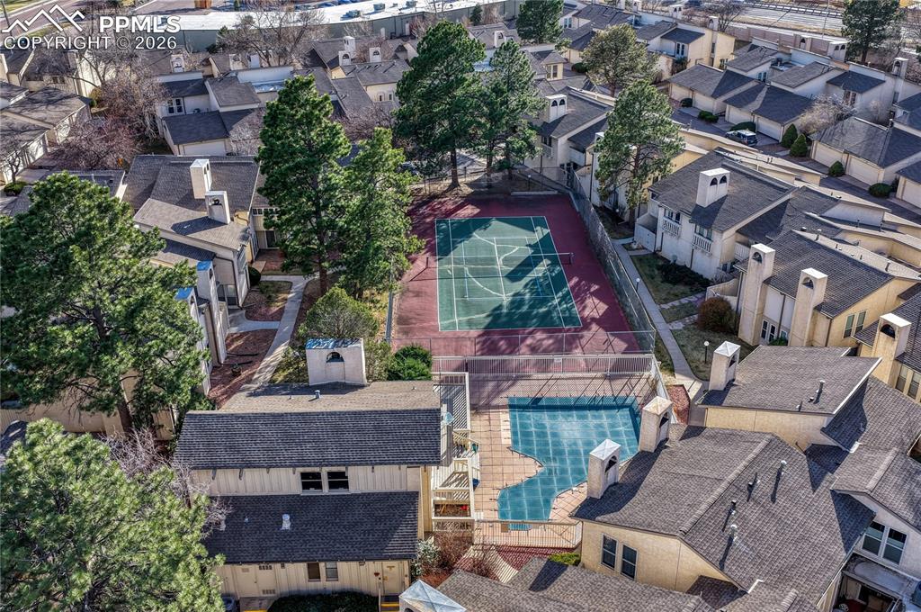 Image 42 of 50: Clubhouse with pool and pickleball/tennis courts