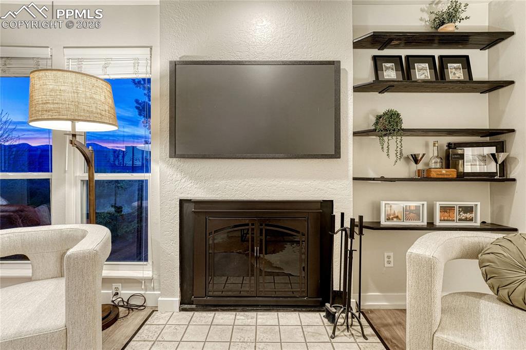 Image 6 of 50: Enjoy the fireplace, TV and mountain views all at the same time