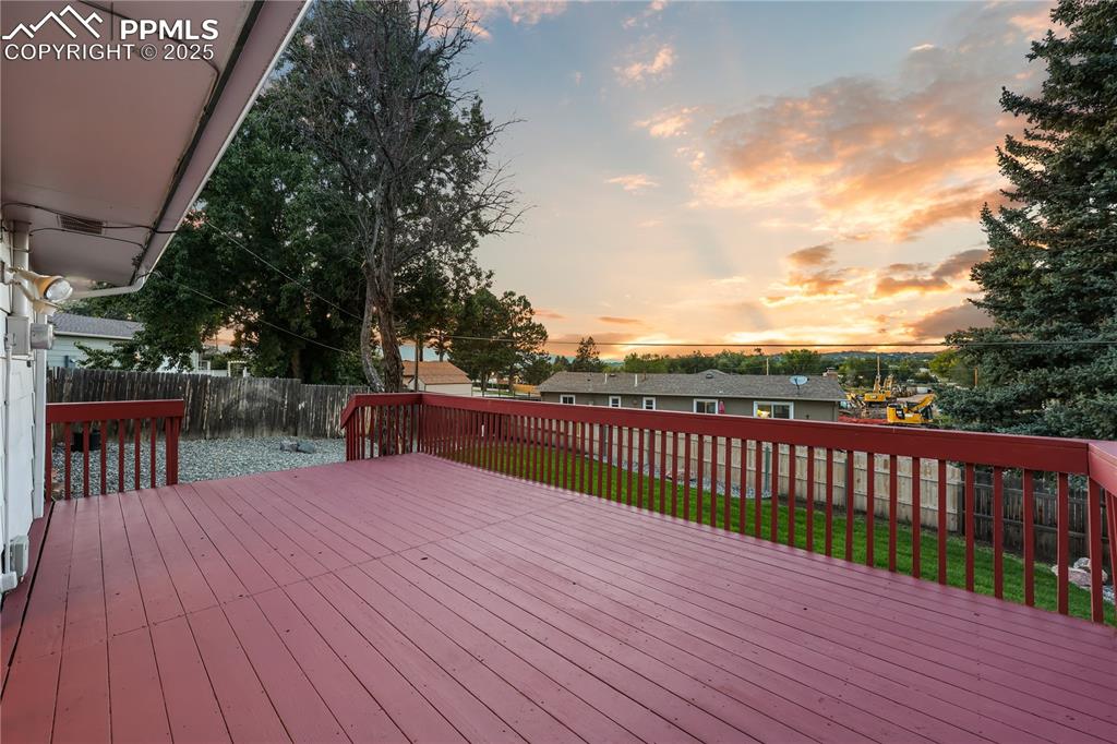 Image 27 of 32: Wooden deck featuring a fenced backyard