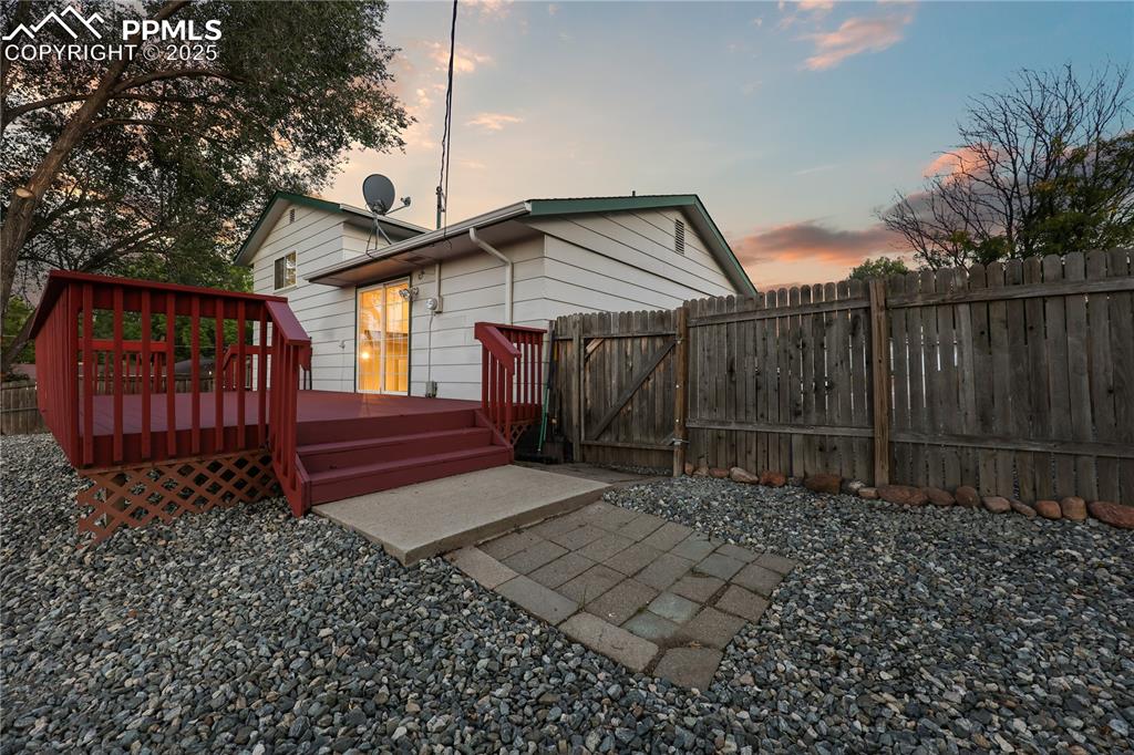 Image 29 of 32: Rear view of property featuring a gate and a wooden deck