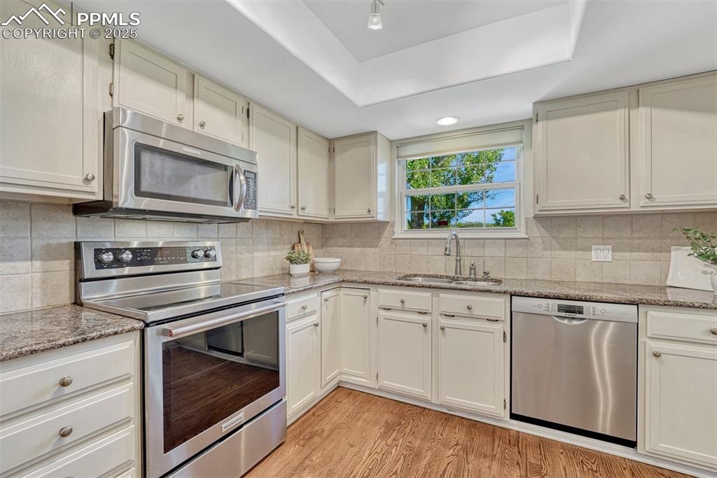 Image 13 of 50: Stainless steel appliances and granite countertops in the Kitchen.