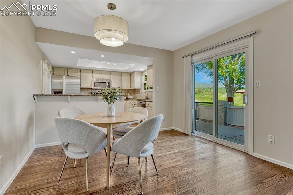 Image 5 of 50: Hardwood Floors and access to back patio in Dining Room