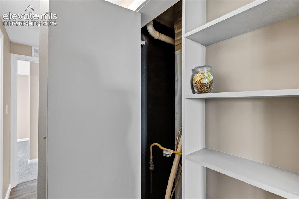 Image 20 of 46: bookshelf is actually custom flush mounted doors to your utilty closet