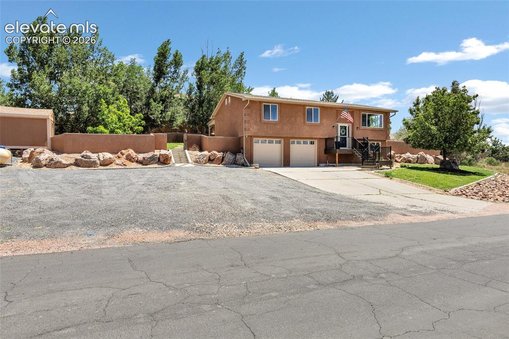 Image 33 of 46: Stucco exterior residence with an attached two-car garage and plenty of roo