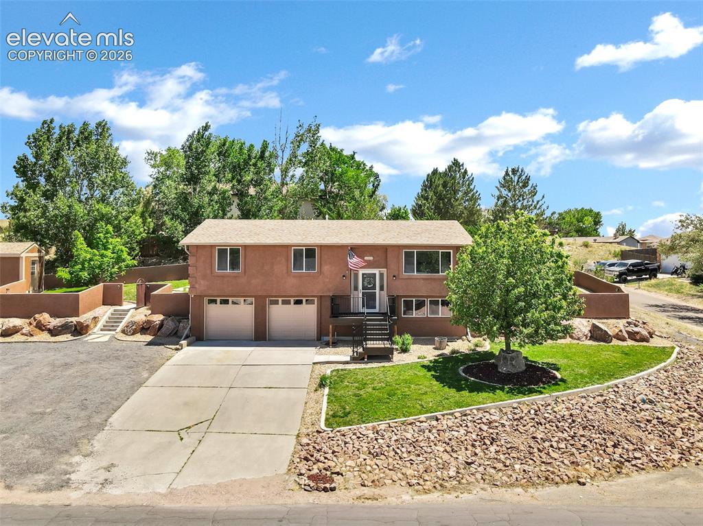 Image 35 of 46: Southwestern-style residence featuring a two-car garage, upper-level entry 
