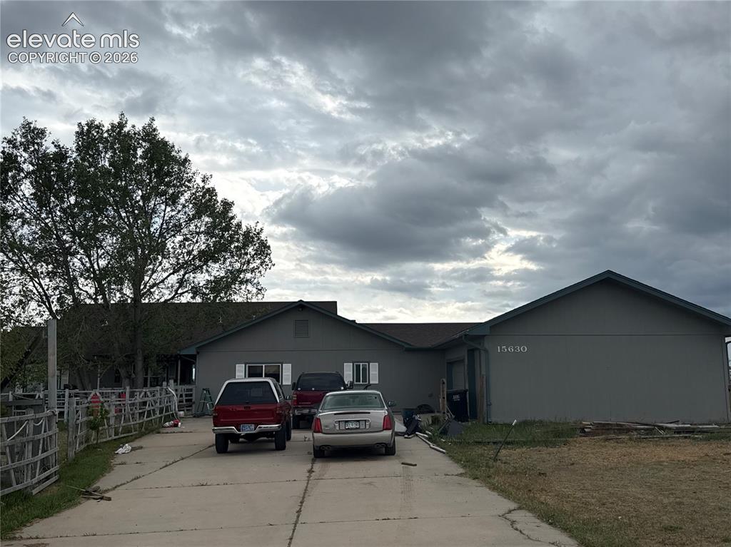 Image 2 of 3: Ranch-style residence featuring a prominent front gable, a paved driveway, 