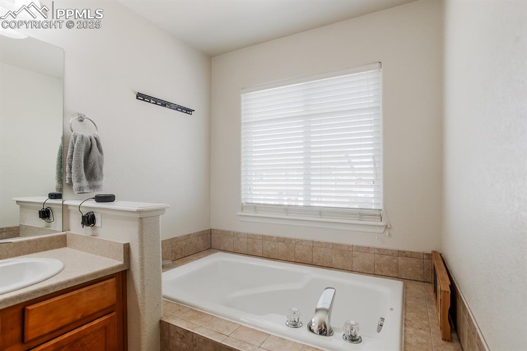 Image 29 of 49: Bathroom featuring vanity and a bath
