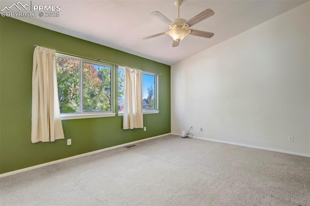 Image 10 of 50: Spare room with carpet floors and a ceiling fan