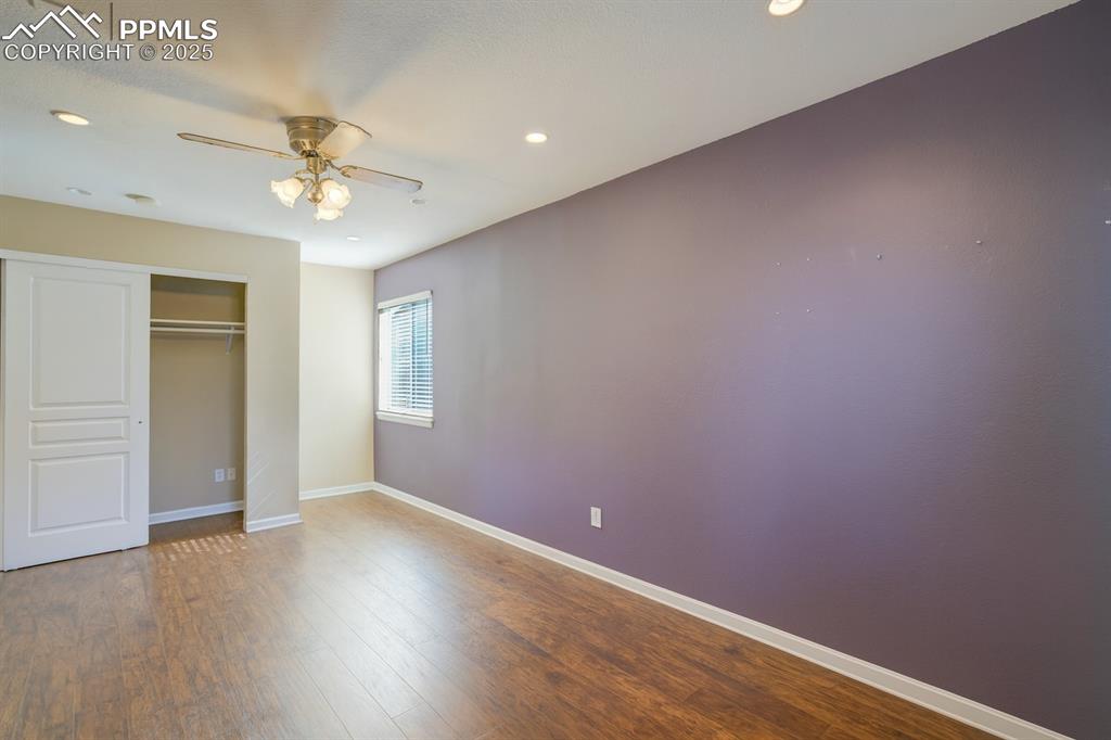 Image 27 of 50: Unfurnished bedroom with dark wood-style flooring, recessed lighting, a cei