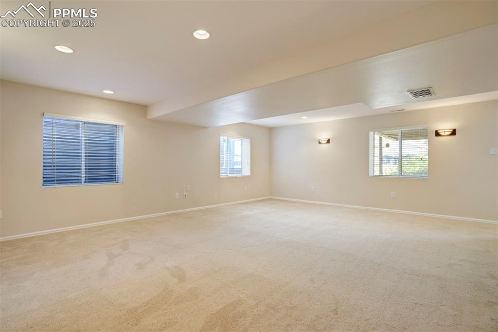 Image 35 of 50: Empty room with recessed lighting and carpet