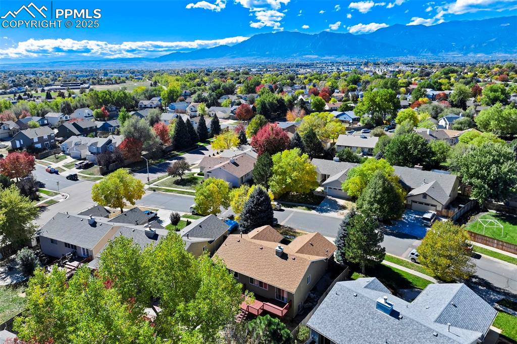 Image 48 of 50: Aerial perspective of suburban area featuring a mountainous background
