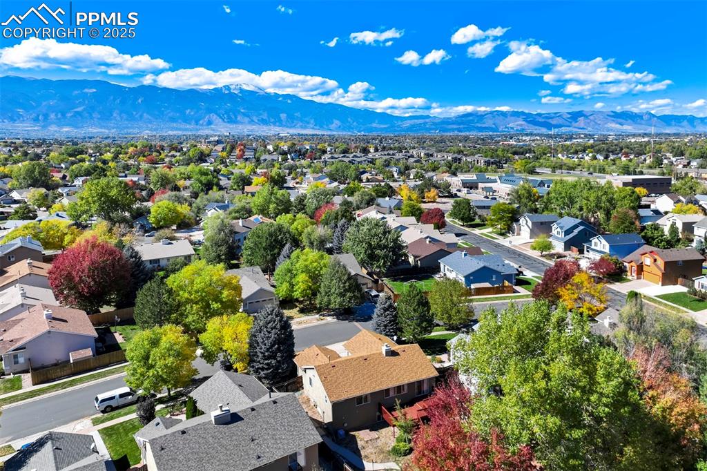 Image 49 of 50: Aerial view of residential area featuring mountains
