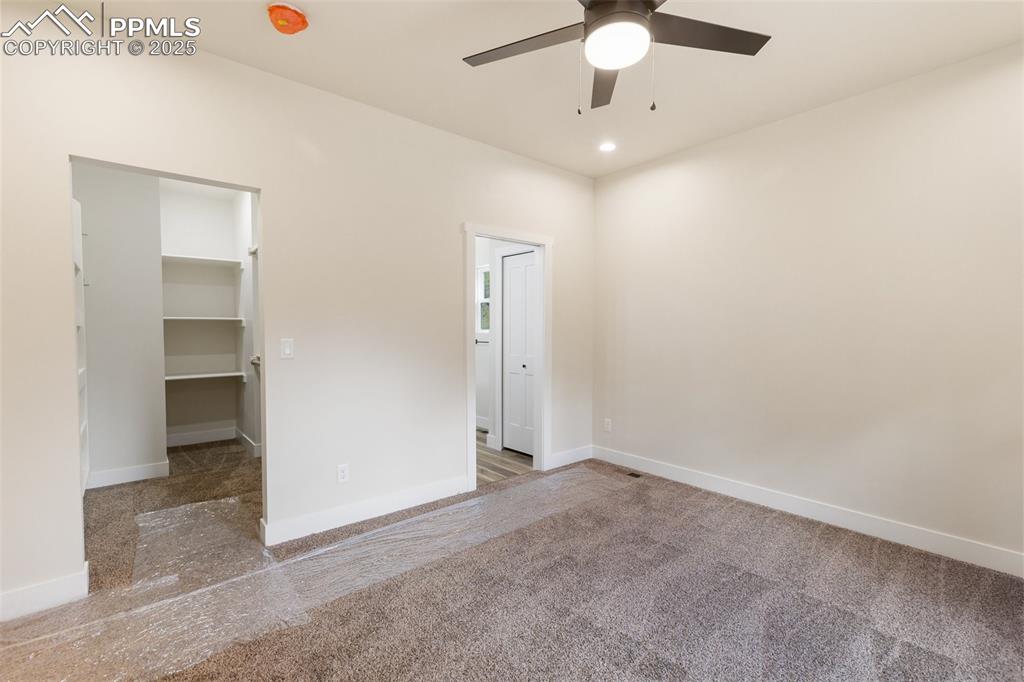 Image 19 of 35: Unfurnished bedroom featuring a walk in closet, recessed lighting, a ceilin