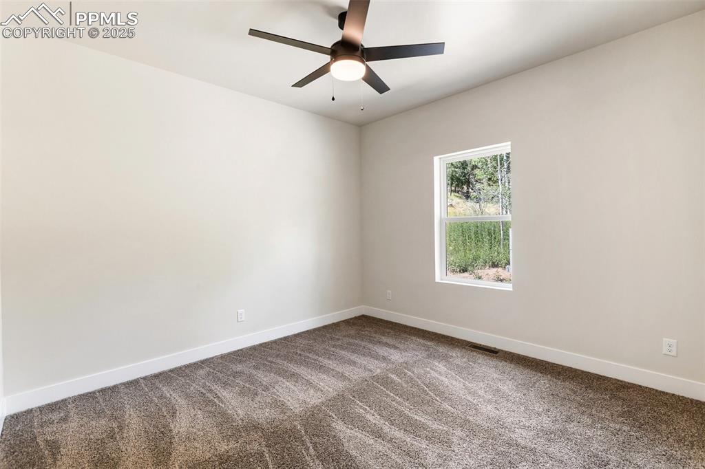 Image 34 of 35: Spare room featuring carpet flooring and a ceiling fan