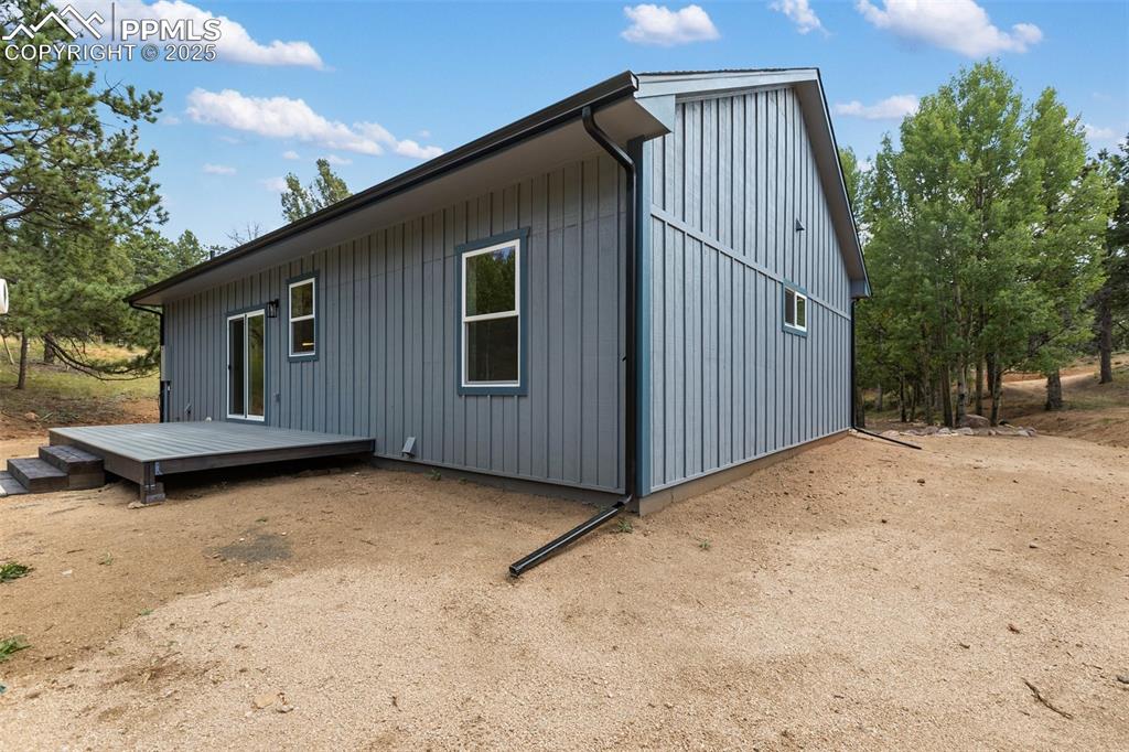 Image 5 of 35: View of side of property with a deck