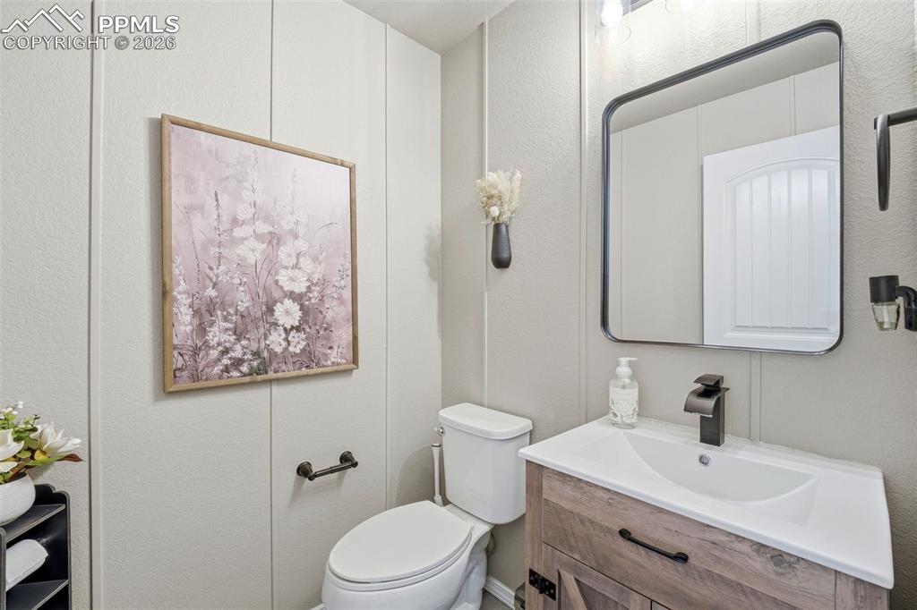 Image 17 of 48: Bathroom with vanity and a textured wall