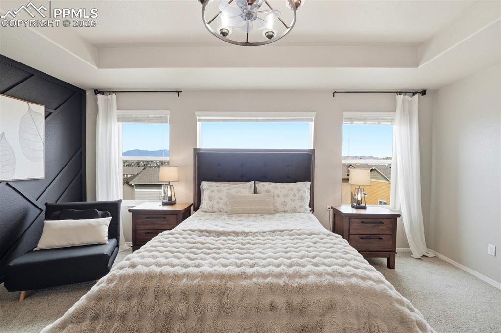 Image 20 of 48: Bedroom featuring carpet and suspended lighting