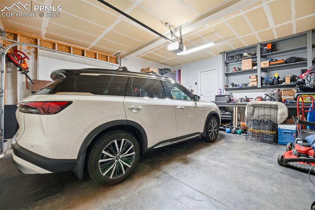 Image 38 of 48: Garage with a garage door opener