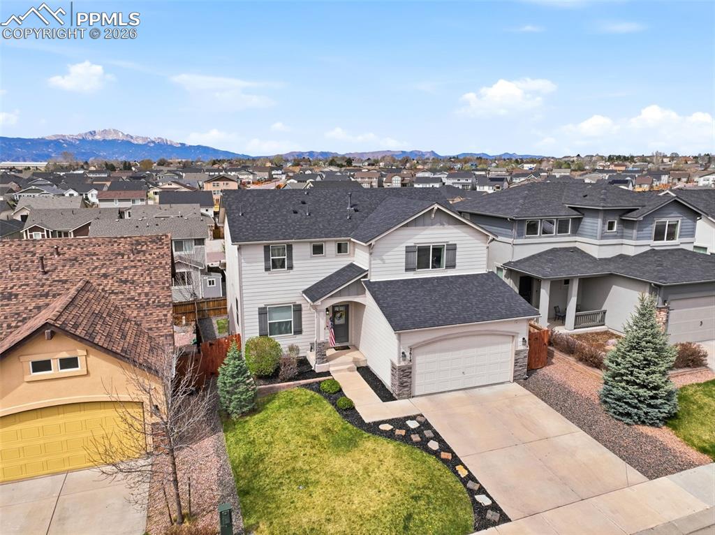 Image 43 of 48: Traditional-style home featuring driveway, a residential view, a shingled r