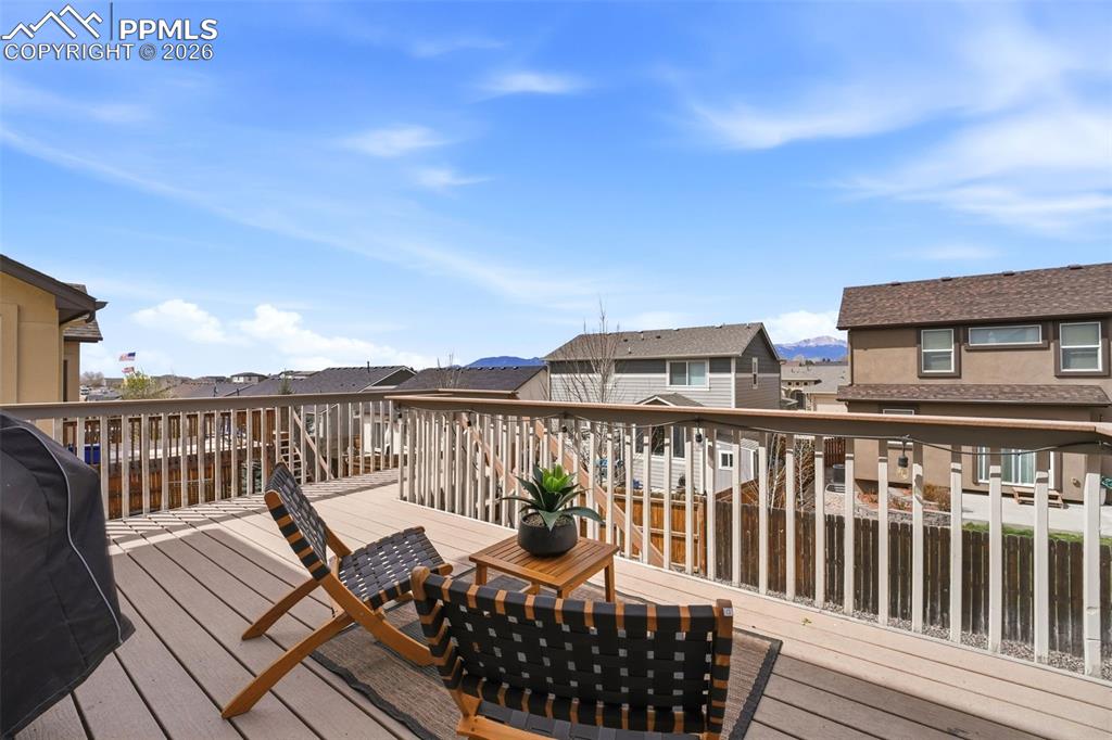 Image 5 of 48: Wooden terrace with a residential view and grilling area