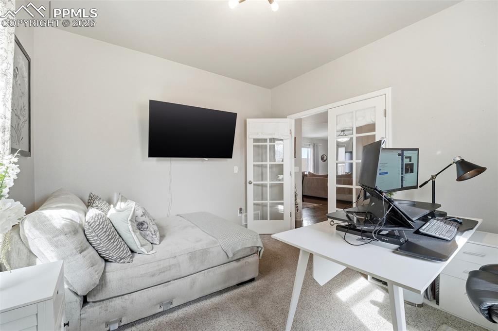 Image 7 of 48: Office featuring french doors and carpet