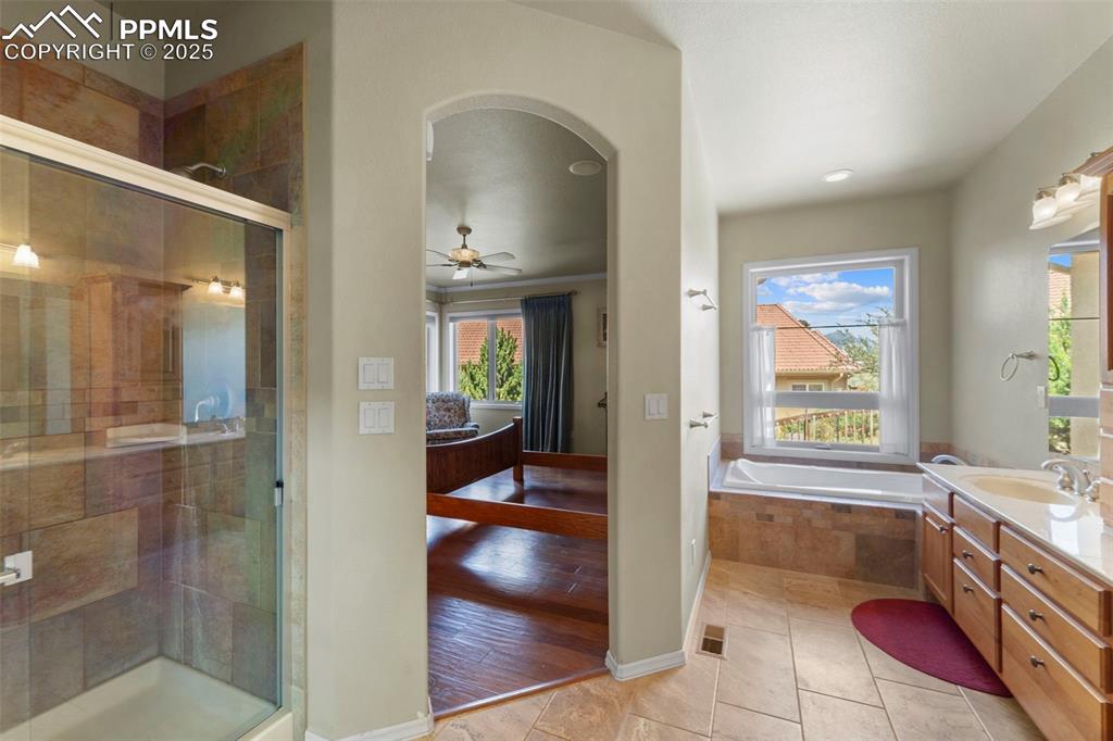 Image 12 of 33: Double sinks, jet tub, shower, and huge walk-in closet in primary bedroom
