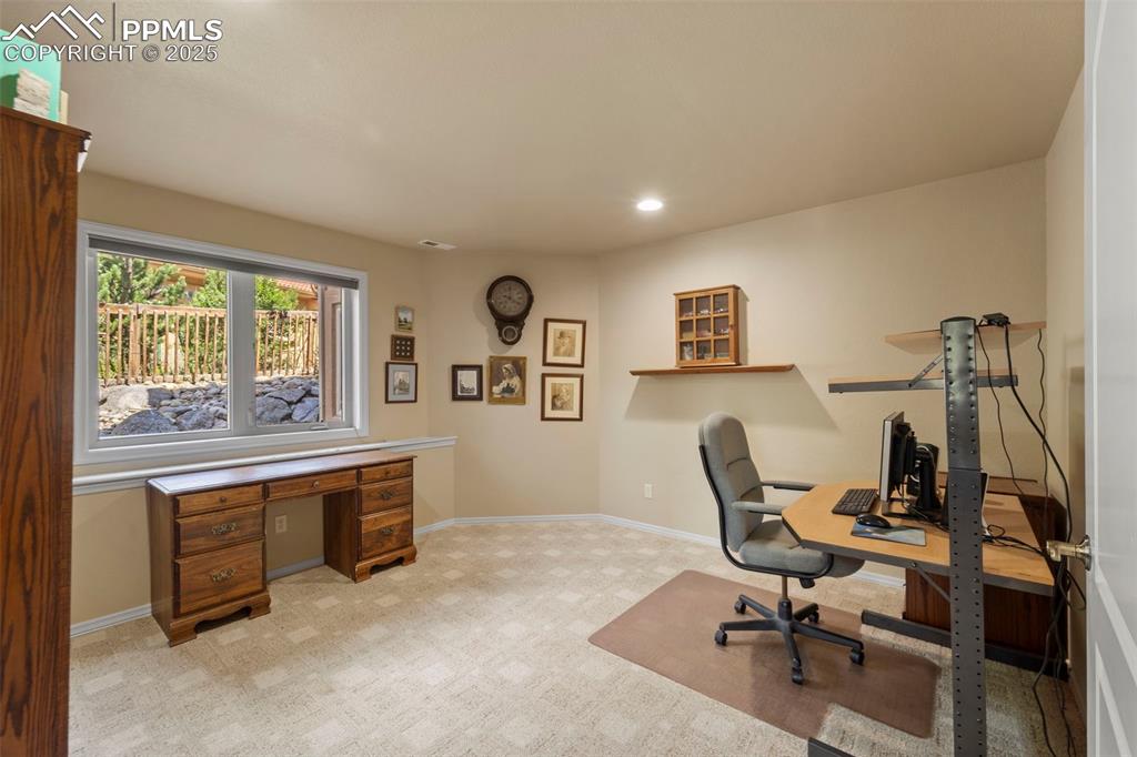 Image 20 of 33: Lower level non-conforming bedroom (no closet) currently used as an office