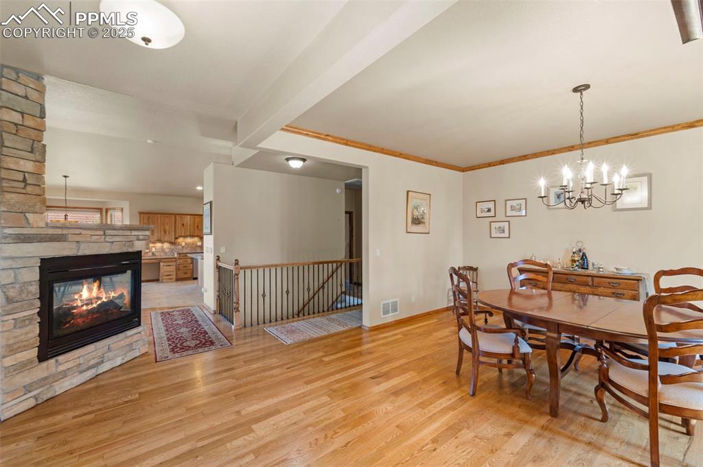 Image 5 of 33: Formal dining and 3-sided fireplace upon entry