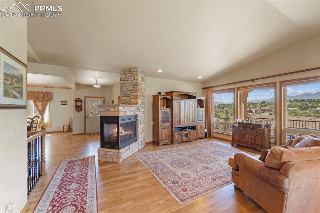 Image 6 of 33: Living room with wood floors and huge picture windows with unobstructed vie