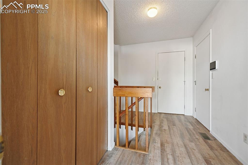 Image 14 of 39: Entry Hallway with large coat closet and brand new flooring!