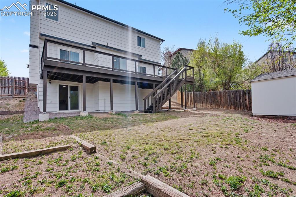 Image 38 of 40: Backyard with Storage Shed for Added Convenience
