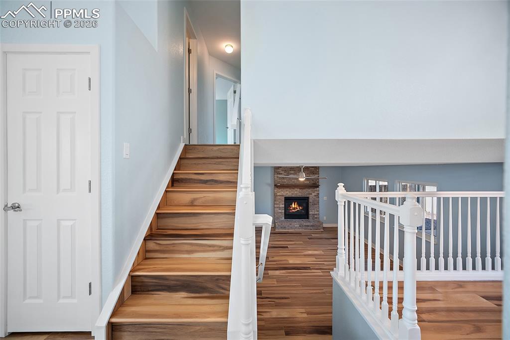 Image 9 of 26: Stairs to upstairs and lower living room area.