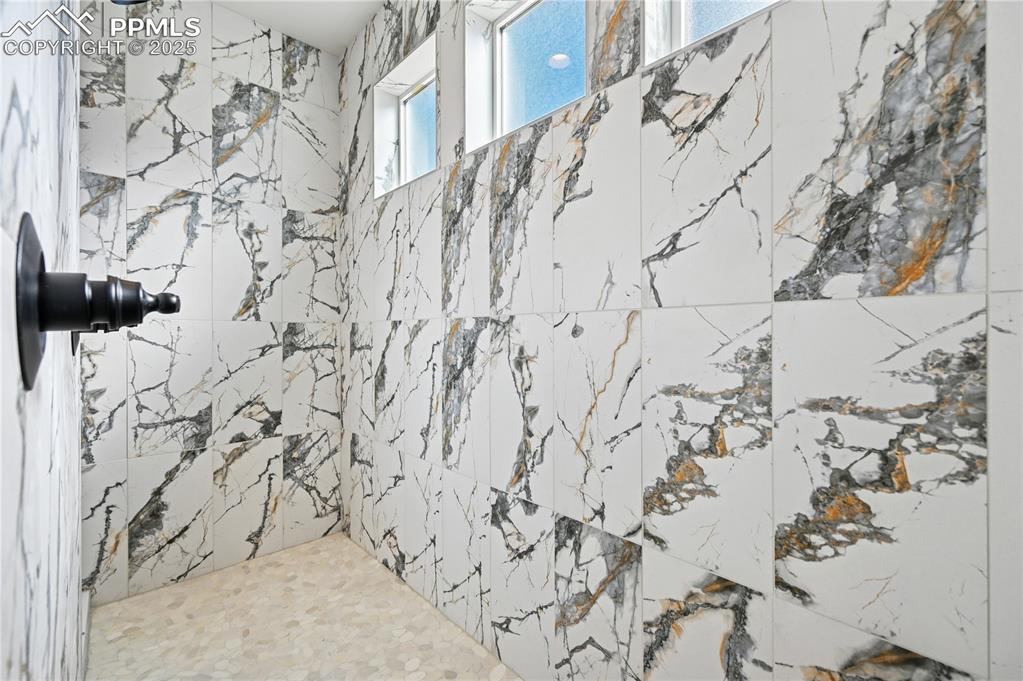 Image 12 of 36: Bathroom with a tile shower